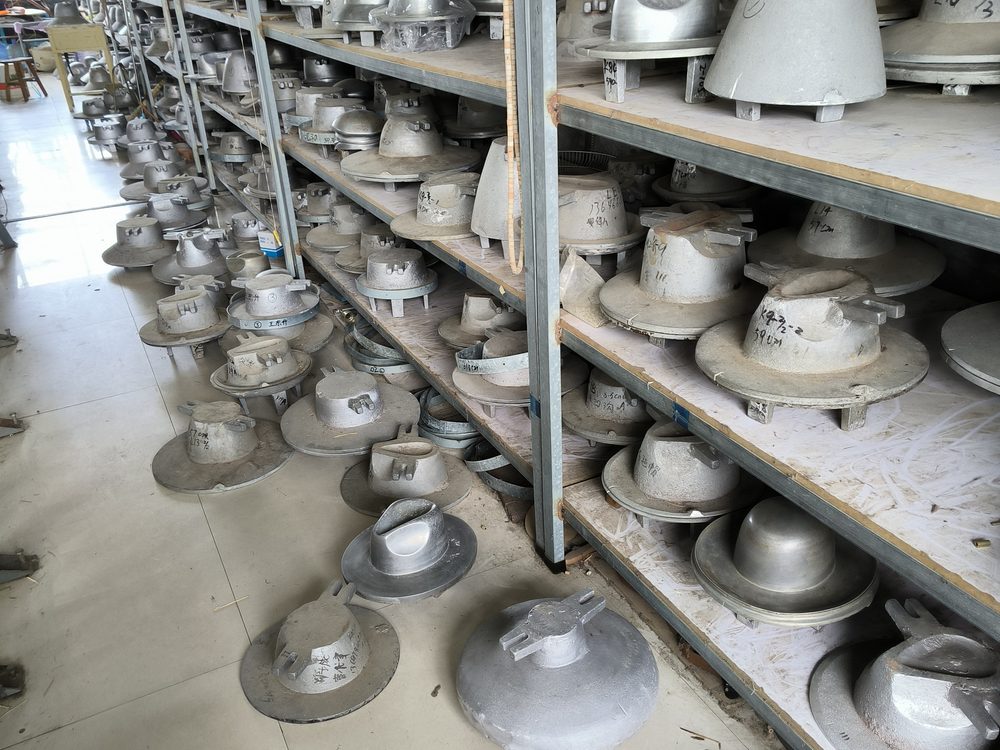 Rows of aluminium hat blocks and tooling on factory shelving