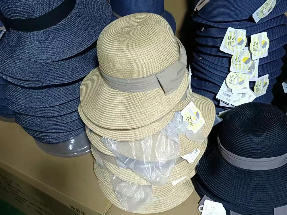 Tagged straw hats packed and staged on export cartons
